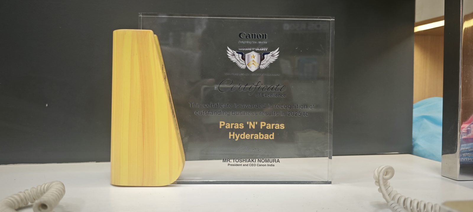 Canon India Wings of Glory Certificate of Excellence awarded to Paras N Paras Hyderabad, signed by Toshiaki Nomura, President and CEO of Canon India